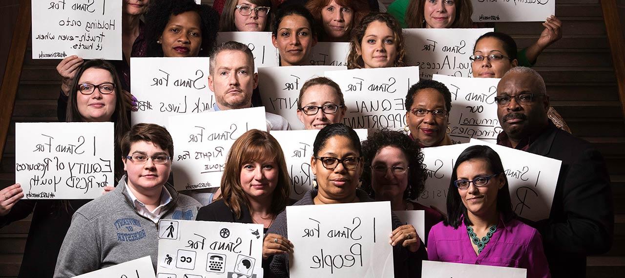 A group of people holding signs