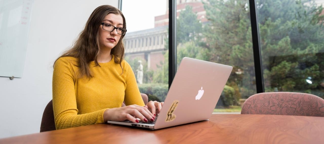 A woman studying at a table.