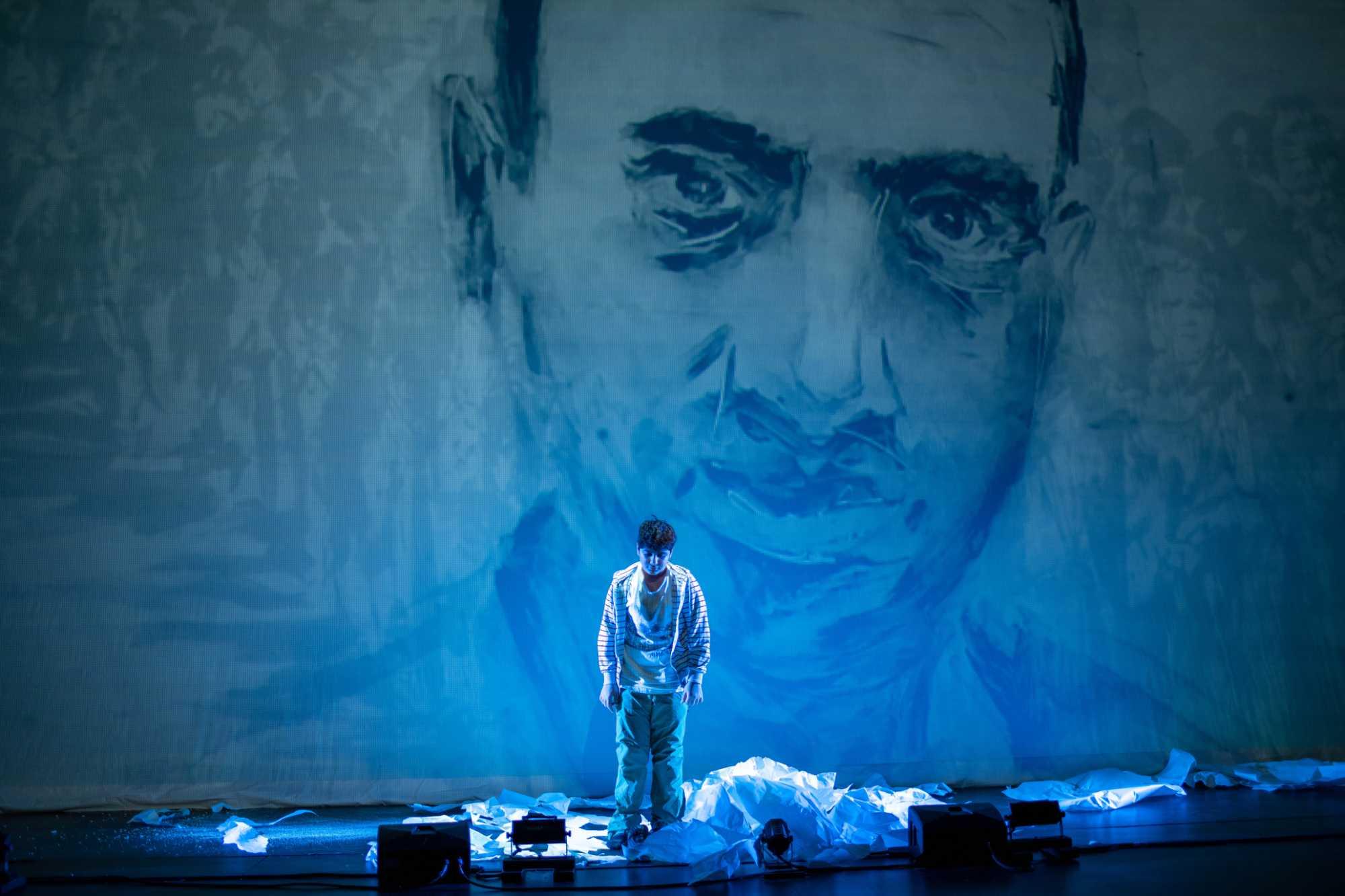 View of the stage bathed in blue light during the premiere of Paper Pianos, which won the Pulitzer Prize for Music.