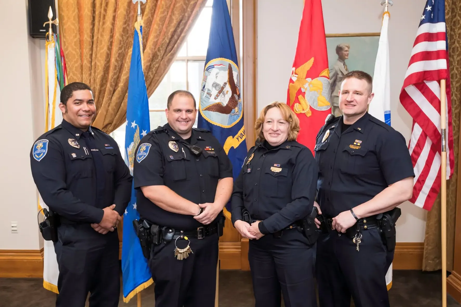 A group of University of Rochester Public Safety officers posing for the camera after a pinning ceremony