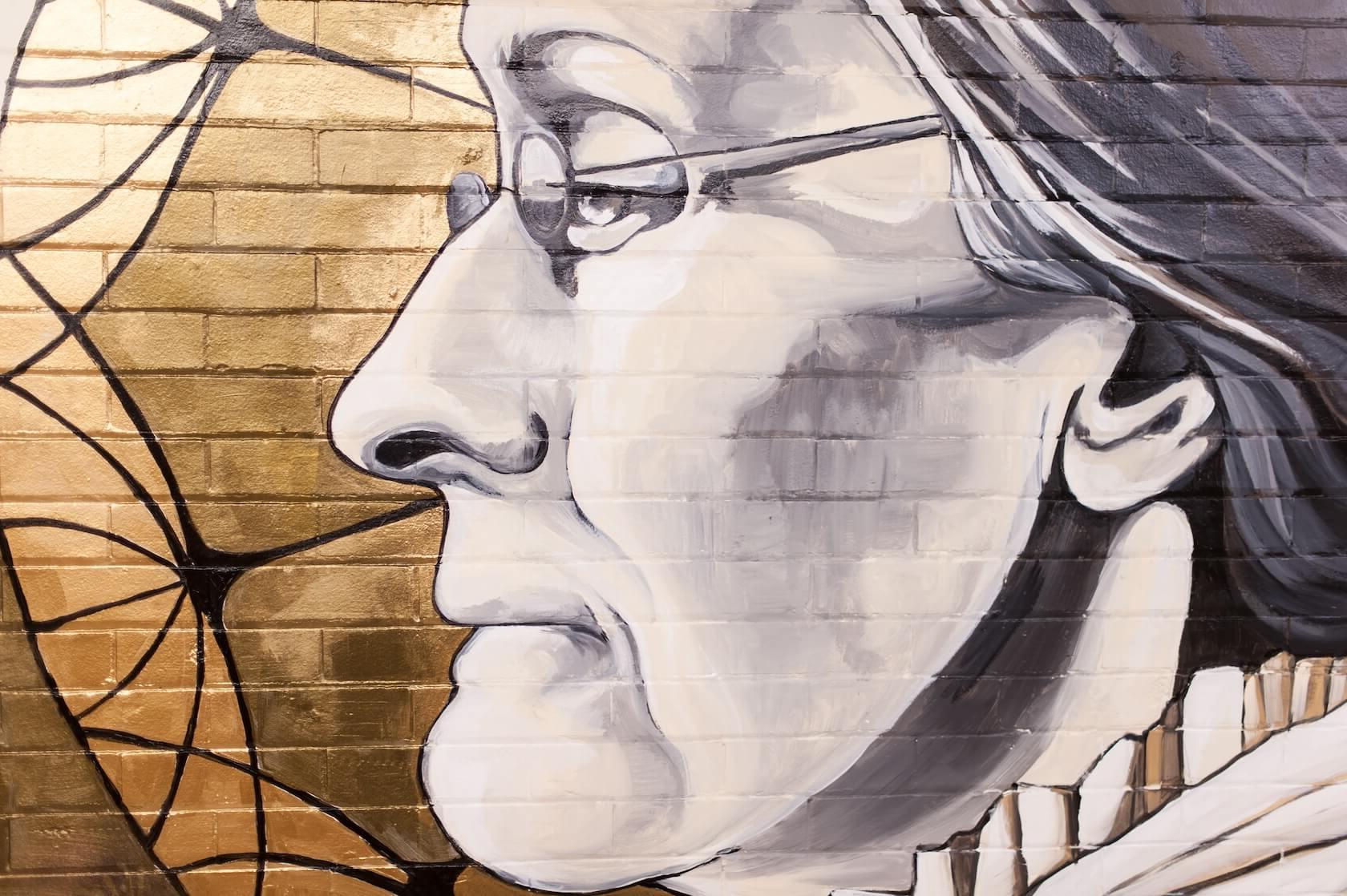 Rochester artist Sarah Rutherford paints a mural featuring Susan B Anthony on a tunnel wall under Dewey Hall March 30, 2015. // photo by J. Adam Fenster / University of Rochester